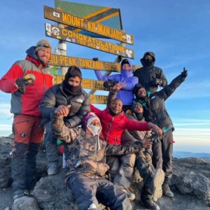 Group celebrating at Kilimanjaro summit